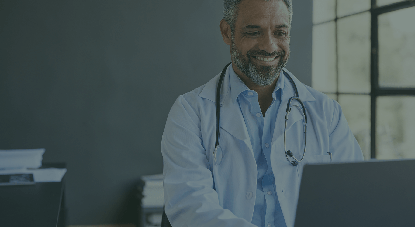 middle-aged-doctor-texting-message-desktop
